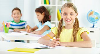 Lovely girl looking at camera with smile during lesson